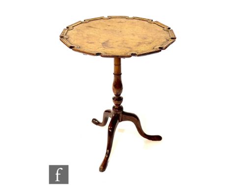 A George III mahogany snap top tripod occasional table, the raised moulded edge shaped top on turned fruitwood baluster pedes