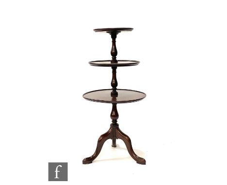 A 19th Century George III style three tier dumb waiter on turned baluster supports and splayed tripod legs, height 88cm. 