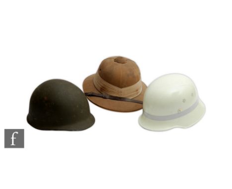 An American army helmet together with a pith helmet made by Wegener and a late 20th Century Norwegian fire brigade luminous h