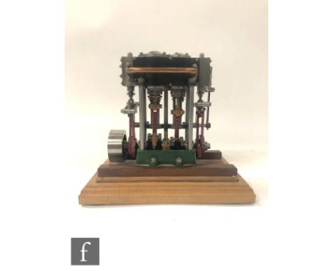 A Stuart twin cylinder marine engine, finished in green and mounted to a stepped walnut base, height 18cm, width 20cm.