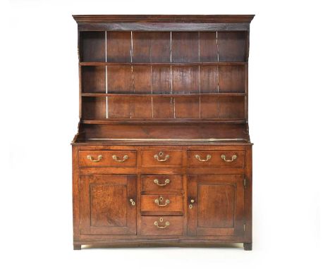 A good, George III oak dresser, North Wales, probably Denbighshire, the slightly canopied three-tier plate rack with a cavett