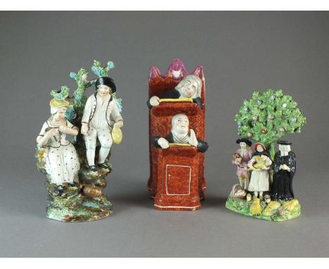 A group of Staffordshire figureslate 18th/early 19th centurycomprising a pearlware group of Vicar and Moses seated at the pul