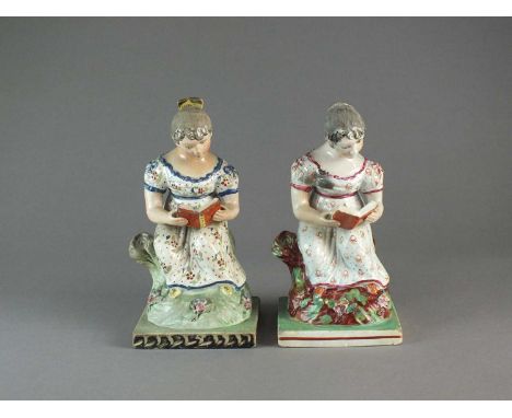 Two similar Staffordshire pearlware figures of reading maidenscirca 1820the young girls modelled seated reading books on squa