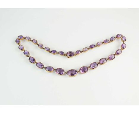 A 19th century amethyst riviere necklace, the twenty-nine graduated oval mixed cut amethysts all set in cut down collet mount