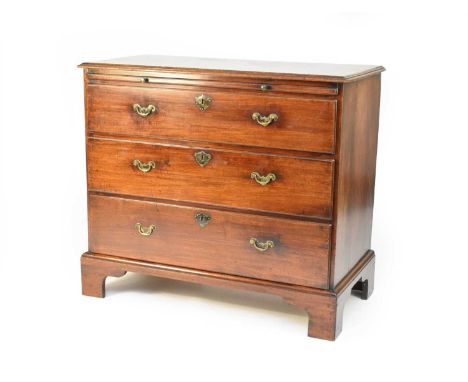 A late George II mahogany chest of drawers, the moulded rectangular top over a brushing slide, with a central writing surface