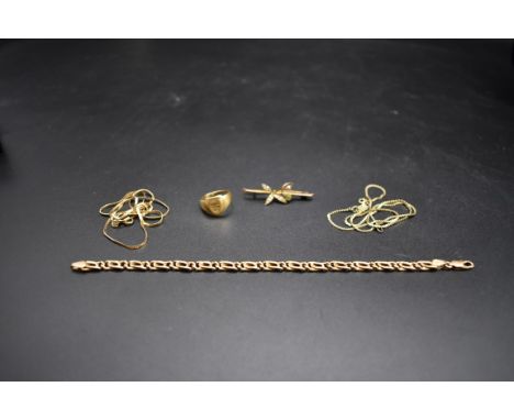 A yellow metal bracelet, stamped 14k, 18cm; together with two necklaces, stamped 14k; a 9ct gold peridot and pearl bar brooch