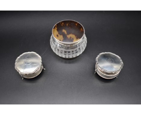 A silver and tortoiseshell lidded cut glass dressing table bottle; together with a pair of engine turned silver ring boxes. (