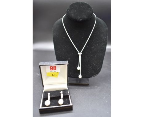 A pair of unmarked metal diamond and pearl ear studs, 29mm; together with a similar 925 pearl and diamond necklace, 40cm. 