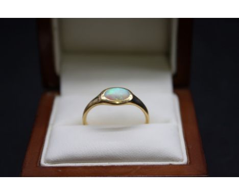 An 18ct gold and oval cabochon opal ring, size P, gross weight 2.8g. 