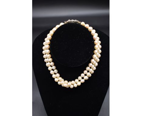 A 19th century three strand pearl choker necklace, having yellow metal clasp set with rose cut diamonds, 33cm. 