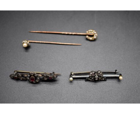 A ruby and diamond set floral bar brooch; together with a diamond and pearl bar brooch; and two diamond and pearl set stick p