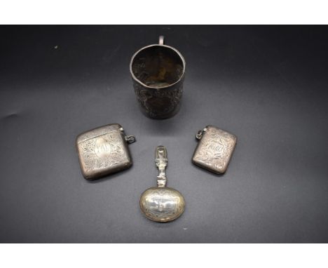Two silver vesta cases; together with a Victorian silver mug; and a Victorian silver caddy spoon, 147g. (4) 