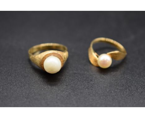 A yellow metal pearl ring,&nbsp;stamped 18k, size M 1/2, together with a similar ring, stamped 750. 