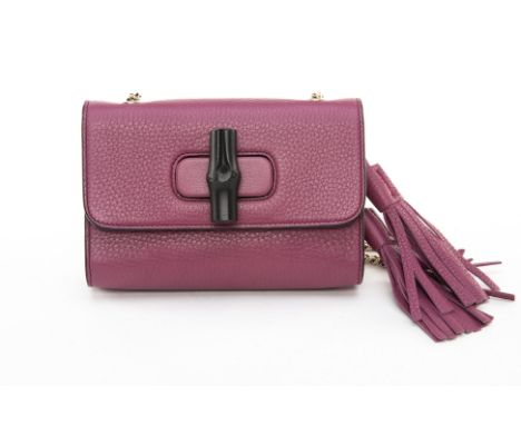 A VINTAGE GUCCI PLUM LEATHER CROSSBODY BAG
Light plum purple calfskin leather crossbody bag, with black bamboo embellishment 