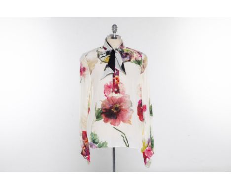 A LANVIN FLORAL SILK BLOUSE
Cream and floral long sleeved button up blouse with a Chinese collar, with a dual sided neck tie
