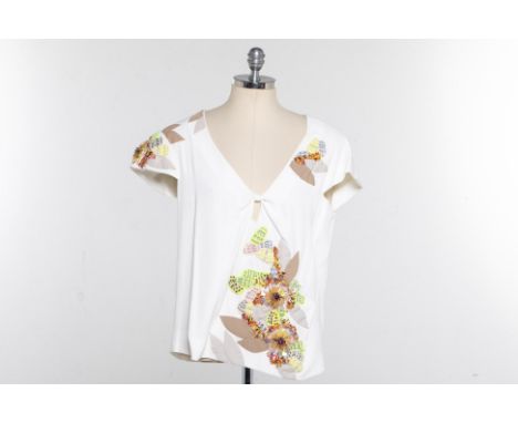 A CHLOE BEIGE FLORAL EMBELLISHED SILK BLOUSE
Short sleeved V neck silk blouse with multicoloured intricate surface embellishm