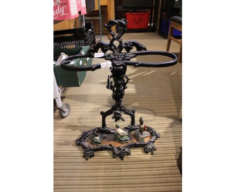 A black finished cast metal stick stand together with three painted cast metal doorstops 