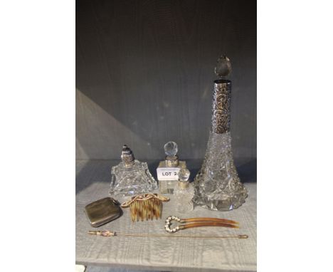 A selection of silver necked glass-based scent bottles, together with a silver Vesta and other ladies hair combs etc. 