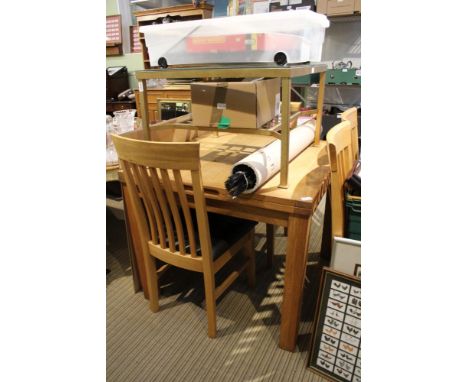 A modern oak dining suite comprising extending rectangular table on plain block legs, together with four stick back chairs wi