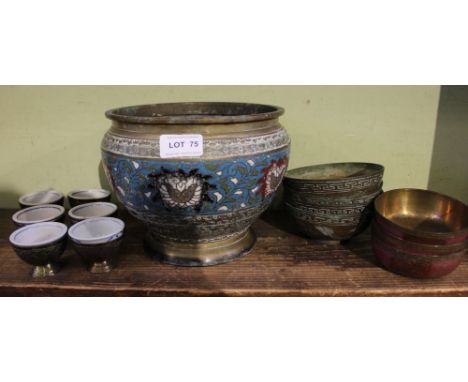 An Oriental brass and cloisonne planter, together with a series of decorated brass bowls and six brass cased ceramic teacups 