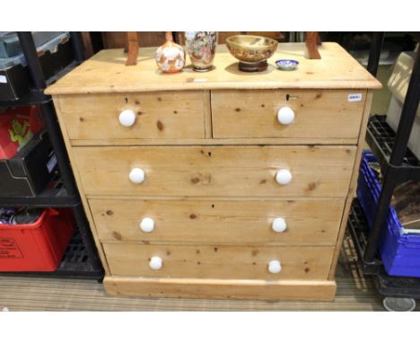 A 19th-century pine finish Chest of five drawers with two in-line and three graduating full width having later white ceramic 