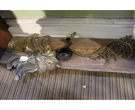 An Early 20th century cast brass gas light fitting, to include a scrolling Rococo wall bracket with wall switch 