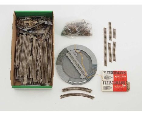 A quantity of unboxed N gauge track to include curves, straights and points, together with a turntable, a bag containing a la
