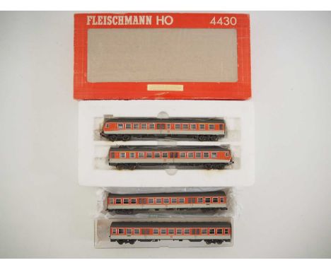 A FLEISCHMANN HO gauge 4431 German outline diesel multiple unit in DB orange/grey together with 2x 4432 centre cars, 4431 in 