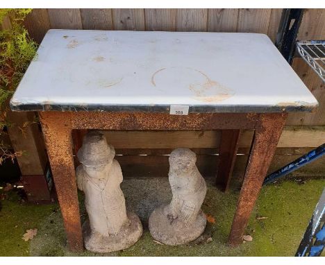 Enamel topped metal based table along with 2 re-constituted stone cricketers