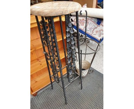 Decorative metal and wooden plant stand along with a metal umbrella stick stand 