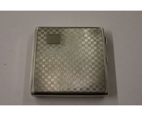 A silver engine turned cigarette case 