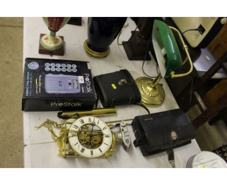 A pair of binoculars; a brass desk lamp; a brass wall clock etc. 