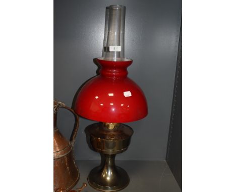 A red glass top shade oil burning lamp with chimney