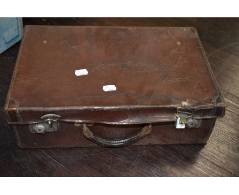 A vintage small leather bound suitcase