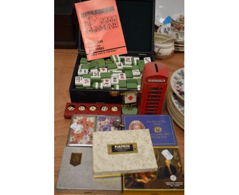 A selection of card games and counters including Mahjong set