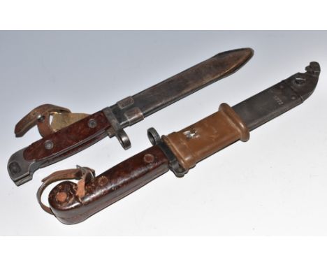 A Polish AKM bayonet and wire cutter, 14.5cm blade, two-piece bakelite grip, scratched numbers TC6772, metal scabbard; anothe