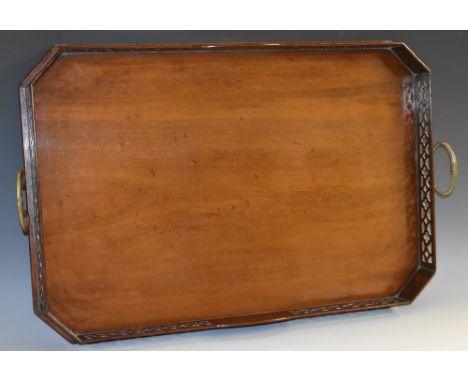 A Gothic Chippendale Revival mahogany canted rectangular gallery tray, the border pierced with tracery, brass handles, 69cm w