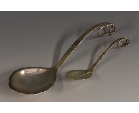 Georg Jensen - a Danish silver pattern No.41 serving spoon, planished overall, 19cm long, import mark for London 1928; a cadd