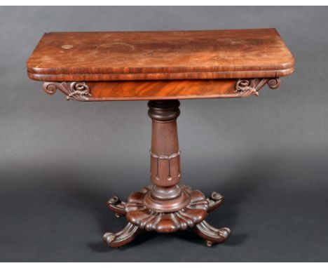 A William IV mahogany rounded rectangular card table, folding top enclosing a baize-lined playing surface, lotus carved socle