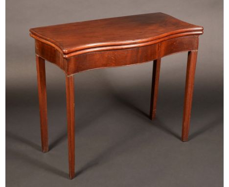 An early George III mahogany shaped rectangular card table, folding top enclosing a baize lined playing surface, dished count