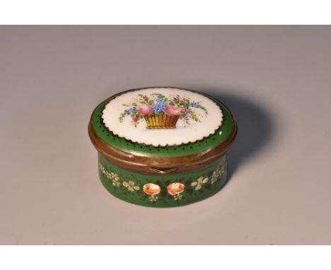 A George III South Staffordshire enamel oval patch box, the hinged cover painted with a central basket of country flowers in 