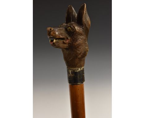 A 19th century novelty silver-mounted Black Forest and malacca walking stick, oversized softwood pommel carved as a German sh