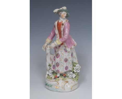 A Derby Patch Mark figure, Huntsman's companion, she stands wearing a pink jacket, hat and patterned skirt by her faithful ho