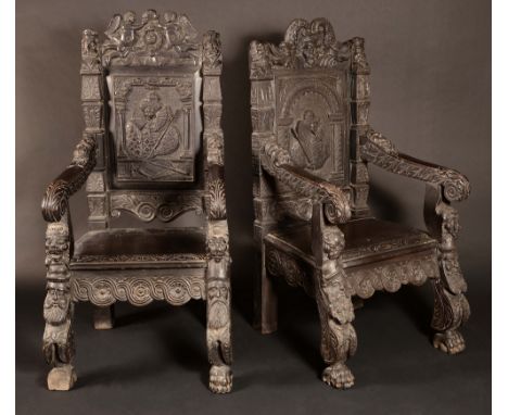 A pair of 19th century Jacobethan oak baronial armchairs, each profusely carved with a portrait of Queen Elizabeth I, masks, 