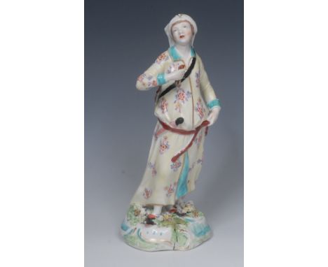 A Derby Patch Mark figure, Abyssinian Archer, he stands holding arrows, wearing a light yellow robe with flowers, 29cm high, 