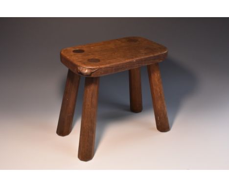 Robert Thompson, Mouseman of Kilburn - an oak four-legged stool, adzed rounded rectangular top, outswept chamfered legs, 30cm