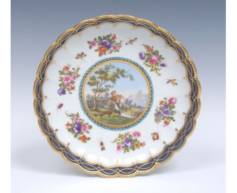 A Worcester Dalhousie style fluted saucer dish, decorated with a central cartouche painted with a landscape and water mill, e