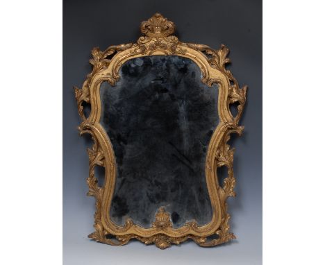 A 19th century Rococo Revival giltwood and gesso looking-glass, the cartouche shaped mirror surmounted by a foliate cresting 
