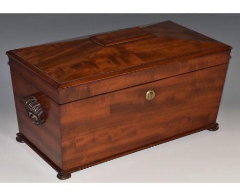 A George IV fiddle-back mahogany sarcophagus tea caddy, hinged cover enclosing a bowl aperture, Bramah type patent lock, bun 