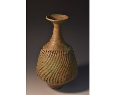 Dame Lucie Rie (Austrian, 1902-1995), a dolomite glaze bottle  vase,  wrythen fluted, long neck with flared rim, 21cm high, s